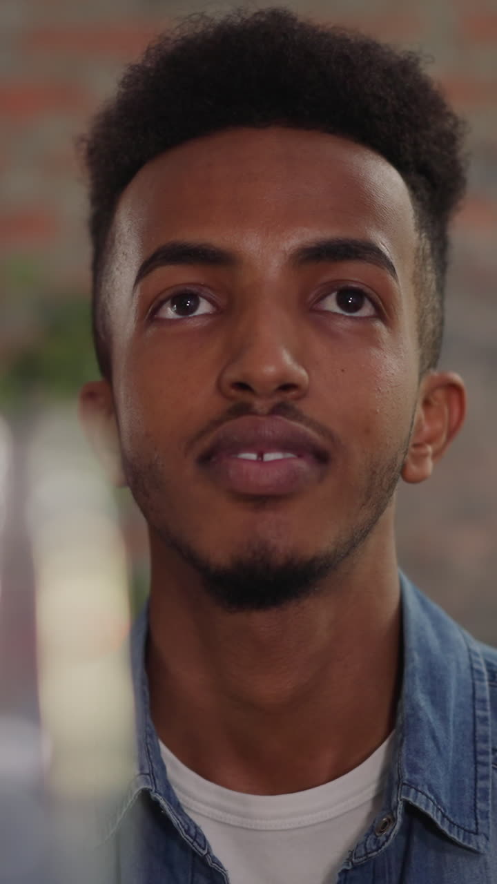 un chico negro barbudo con una mujer rubia mira un partido deportivo visitando a amigos en casa de primer plano en cámara lenta. los amantes del fútbol tienen fanáticos disfrutando del campeonato de fútbol