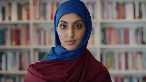 portrait beautiful young muslim woman looking calm independent female wearing hijab in bookshelf background slow motion