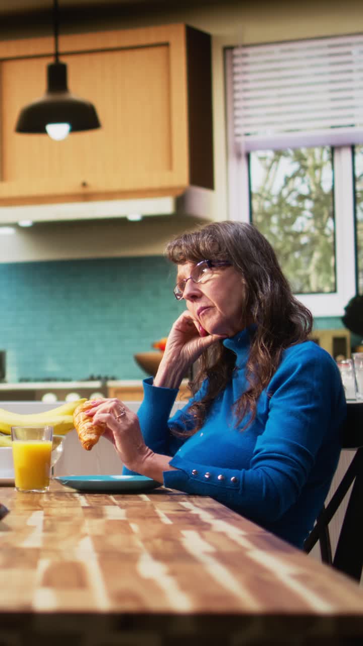 Vertical Video Senior wife looking exasperated and disengaged as husband continues talking