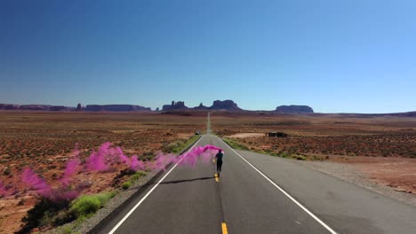 Hombre-Corriendo-En-La-Carretera-En-Utah-Con-Señal-De-Humo-De-Color