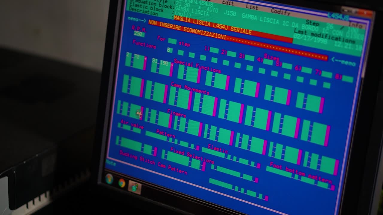 The computer screen controls the production unit and the design of the garment in a socks production factory