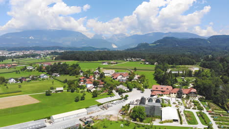 Wide-angle-Dolly-in-aerial-Shot-of-Volcji-Potok-Arboretum-and-the-surrounding-landscape-during-the-day