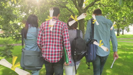 animation of diplomas over back of diverse students talking and walking on sunny day