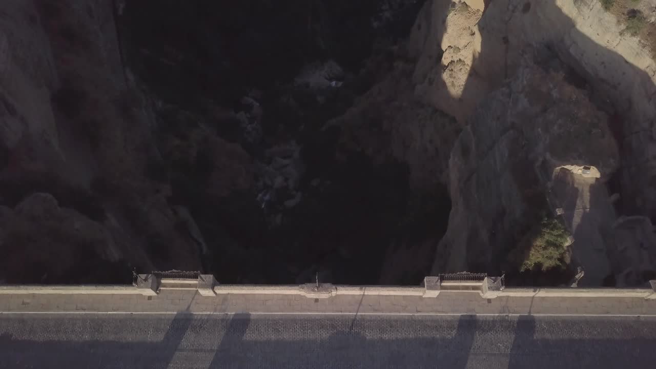 Aerial forward over Puente Nuevo or new bridge a Ronda city in Spain. Top-down view