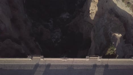 aerial forward over puente nuevo or new bridge a ronda city in spain. top-down view