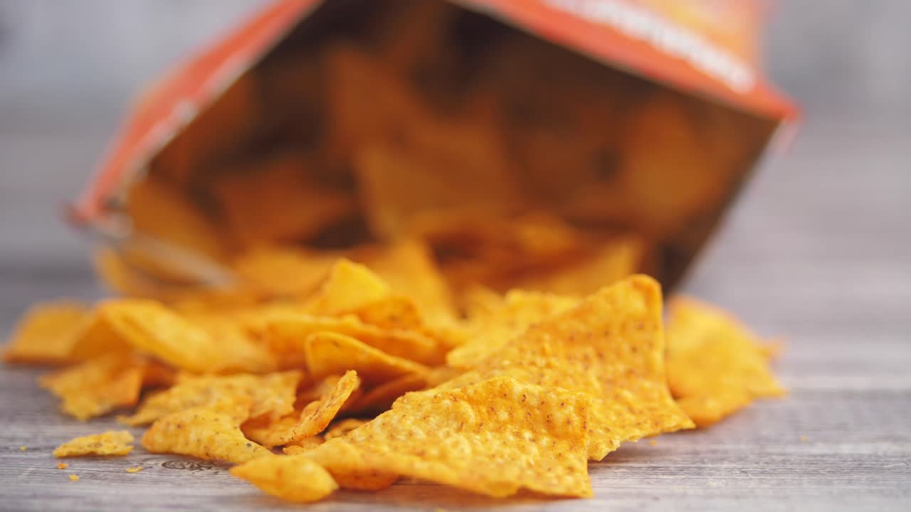 Tortilla chips spilling from an opened bag
