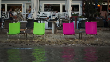 empty chaise-lounges on the beach and outdoor cafe