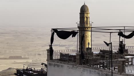 mardin, turkey, cinematic places and people activities - street view -  restaurant view. the ulu cami minaret