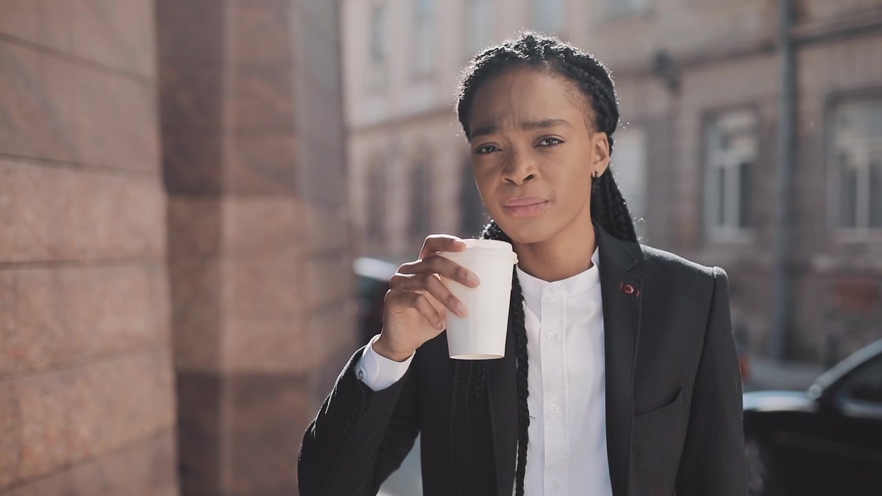 Professional Woman Drinking Coffee Outdoors in City