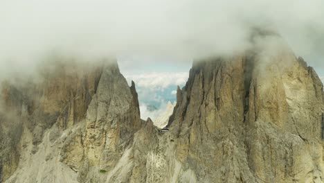 fly high through clouds at langkofel mountain peak, dolomites italy