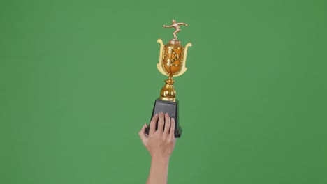 hands holding a bowling trophy