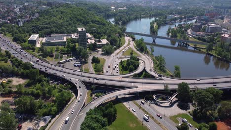 Aerial-drone-view-of-road-junction-or-crossroad-with-traffic-in-Prague,-Czech-Republic,-city-in-background,-sunny-day