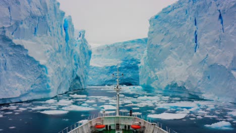a ship navigating through majestic blue icebergs in the antarctic