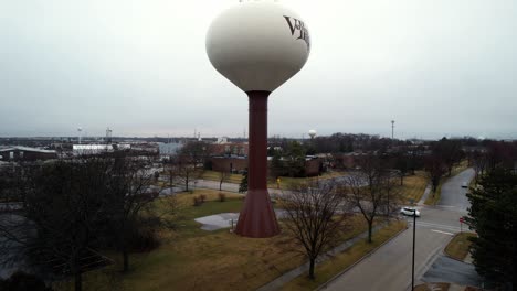 rising drone shot of a water tower in vernon hills, illinois on a rainy day 4k