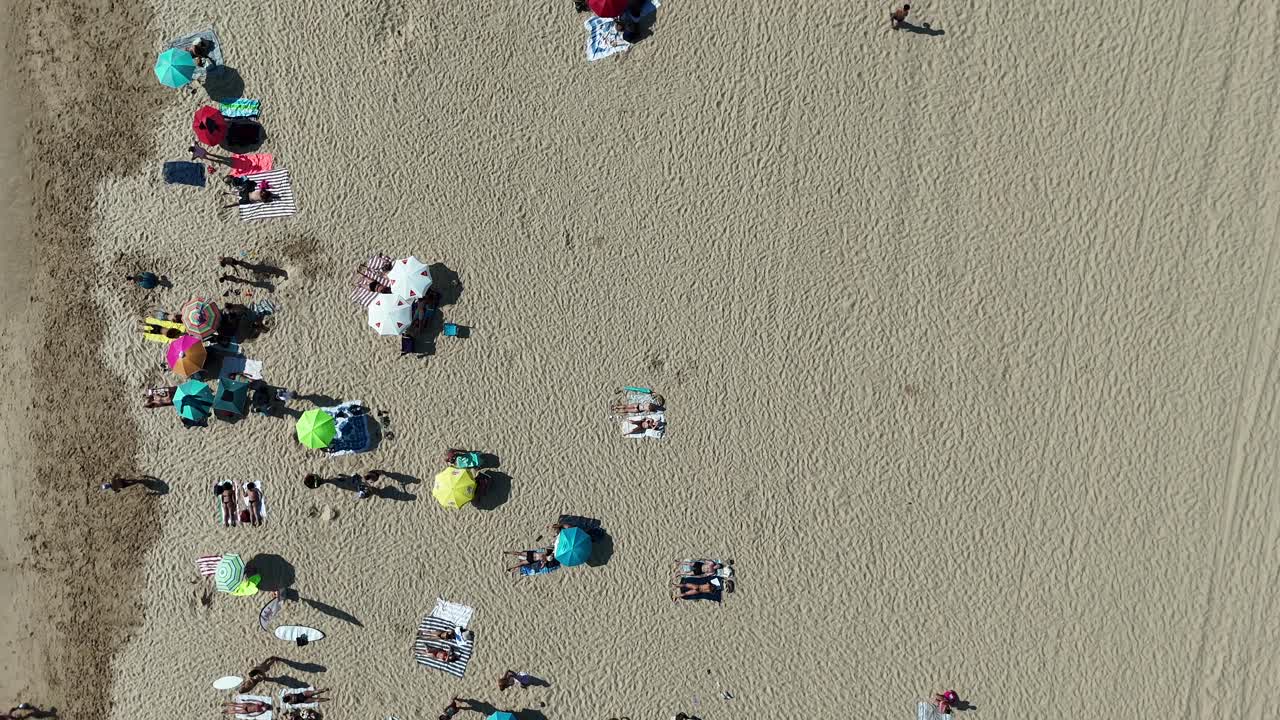 Aerial View of Beach with People and Umbrellas