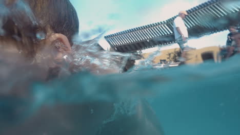 child getting ready and diving in the pool