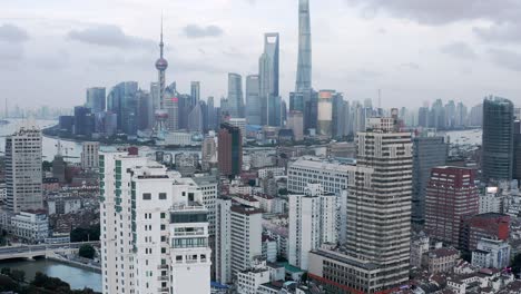 downtown shanghai city skyline, rising aerial view over towers