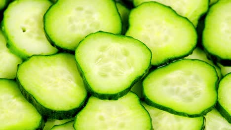 slow motion of rotation ripe green sliced cucumbers. juicy ripe single green cucumber sliced