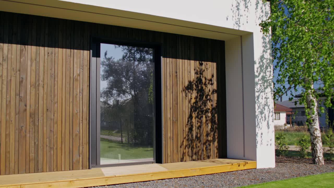 Modern House Exterior with Wooden Siding and Glass Door