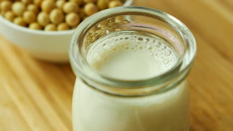 Hot-soy-milk-pouring-in-a-glass-jar-,