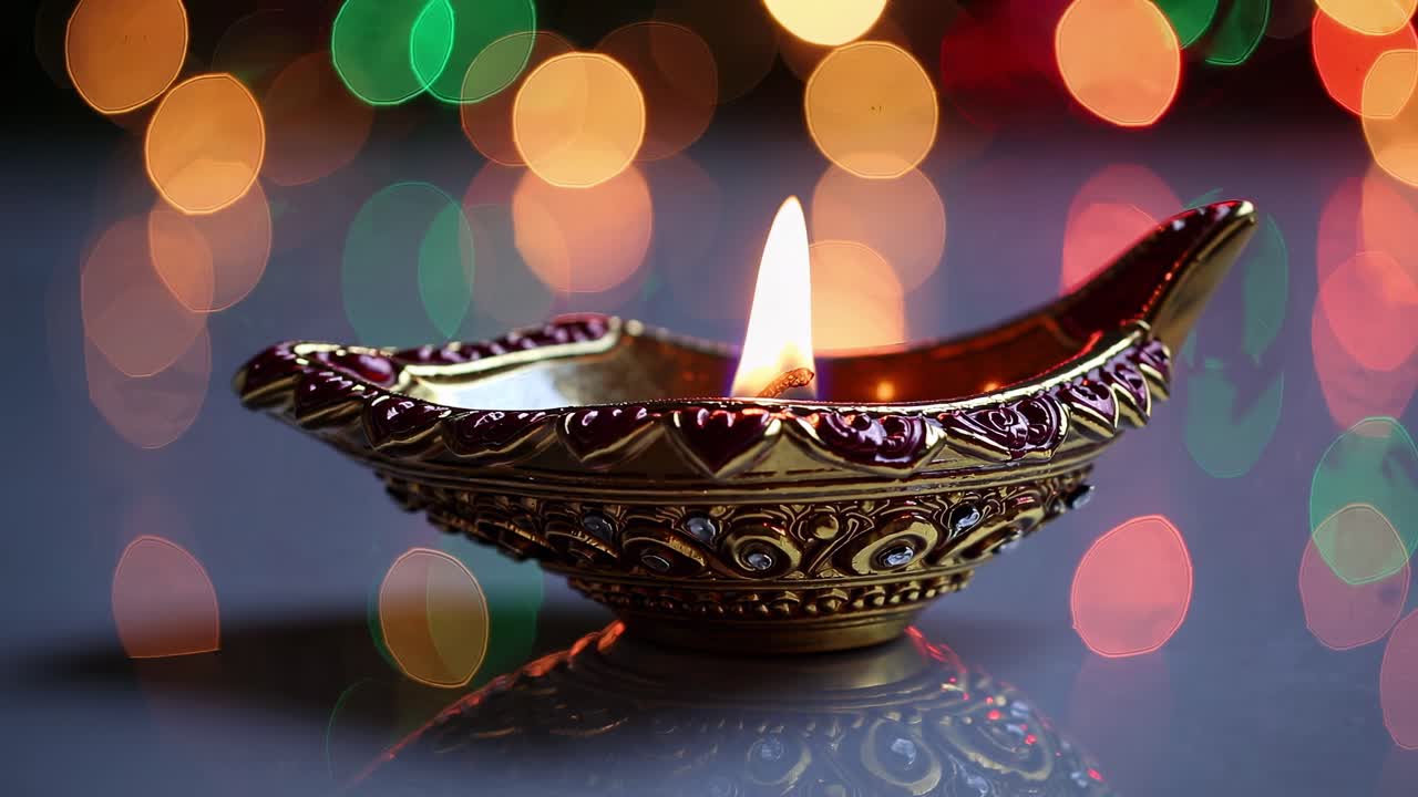 Close-up video of a decorative oil lamp with a lit flame, set against a vibrant bokeh background