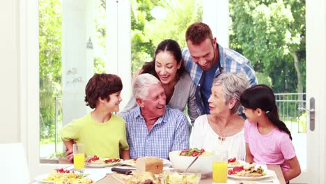 Happy-family-posing-during-lunch-