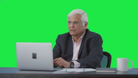 Senior-senior-Indian-manager-doing-a-video-call-Green-screen