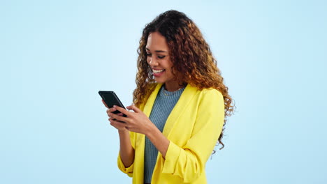 Woman,-laugh-and-typing-with-phone-in-studio