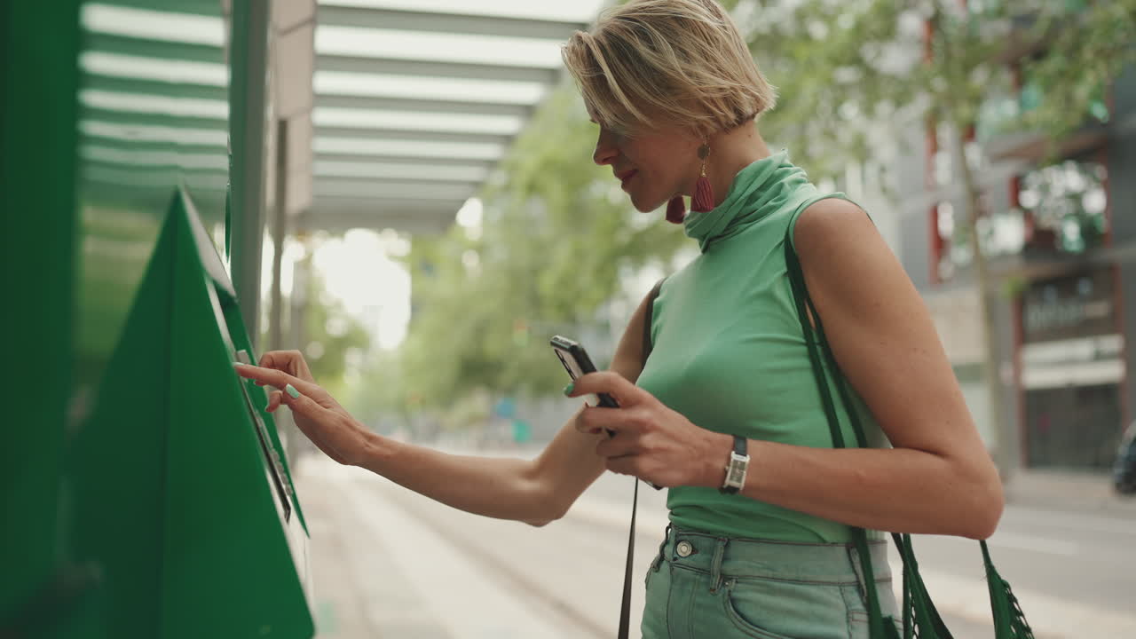 Woman Using ATM on the Street