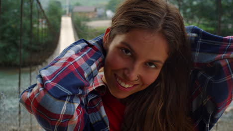 traveler face smiling looking camera outside. happy girl enjoy nature on river.