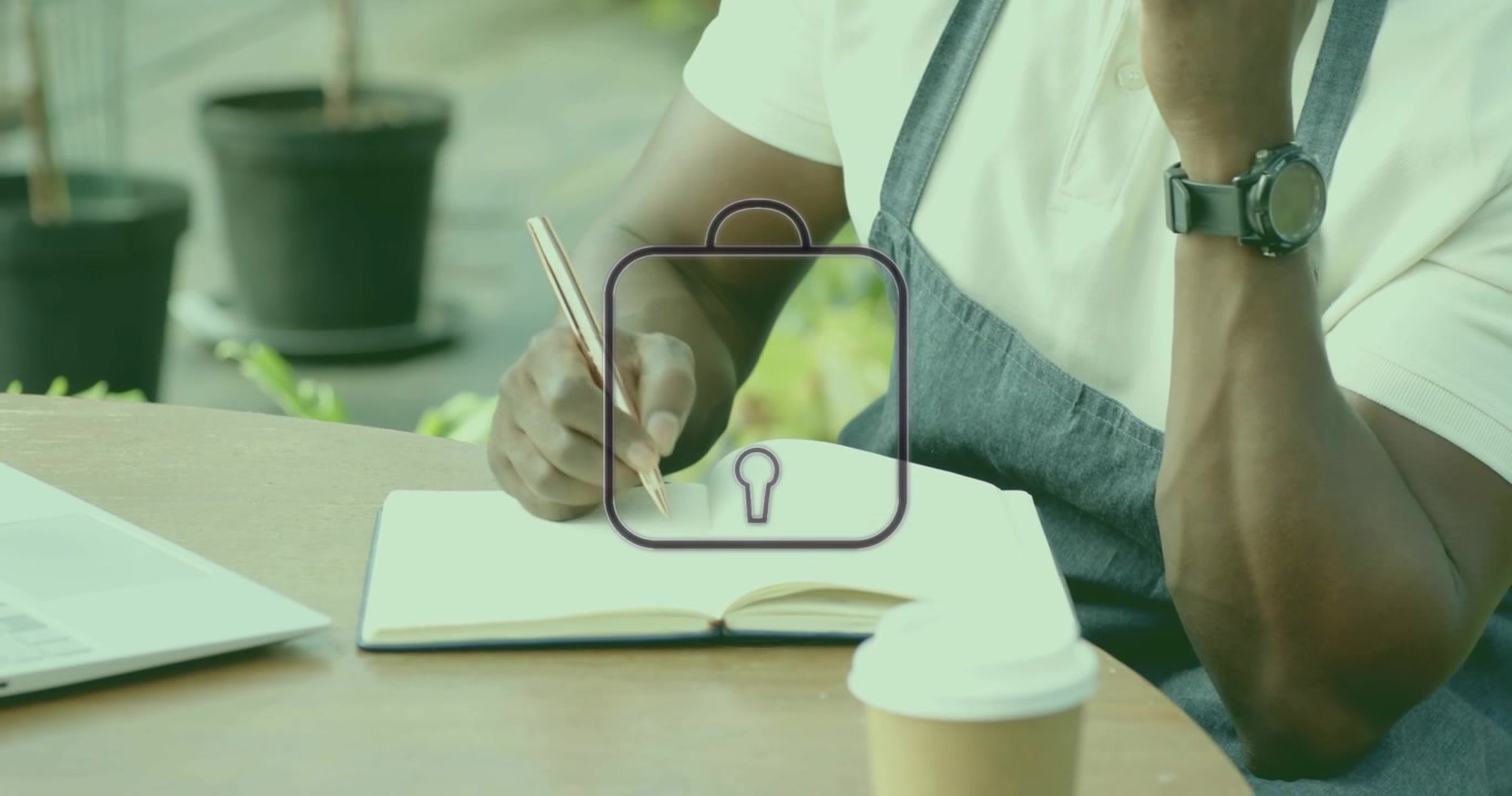 Man receiving phone call writing notes while lock icon filling security then typing on laptop