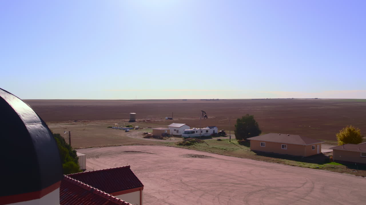 Move in past Bell Tower of Small Church to Farmland