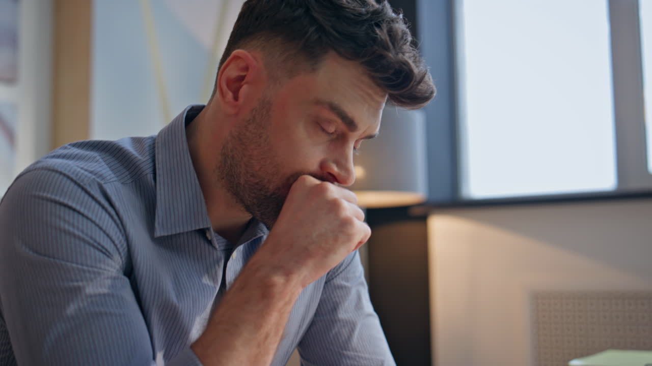Mãos de empresário fazendo anotações no caderno em ambiente interno, em primeiro plano. Homem cansado ponderando