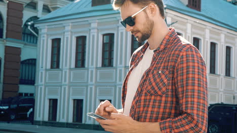 man using a phone on the street