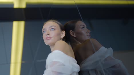 woman in a white dress reflecting in a mirror