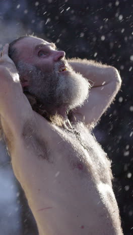 steam rise from man after sauna in snowfall looking up talking to god, vertical