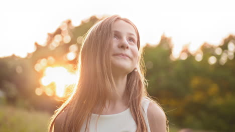 happy girl looking up at sunset