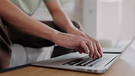 freelancer hands typing on a laptop with a remote