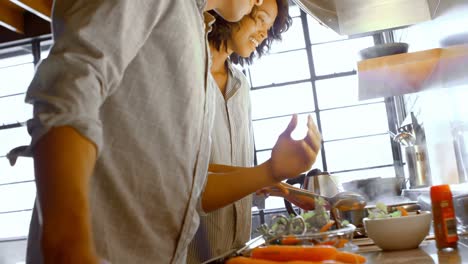 Couple-preparing-food-in-kitchen-4k