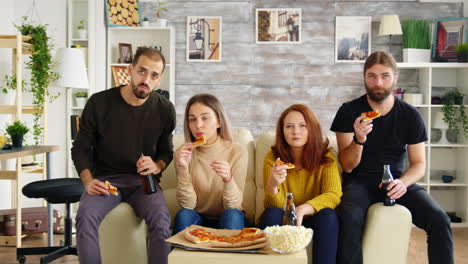 Girl-scared-while-watching-a-horror-movie-with-her-friends