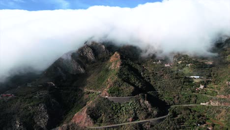 Panning-Aerial-Timelapse-of-Rolling-Clouds-on-Mountain-Overlooking-Highway,-Spain