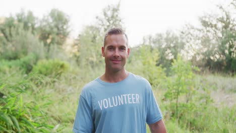 Caucasian-man-smiling-and-looking-at-camera-during-river-clean-up-day