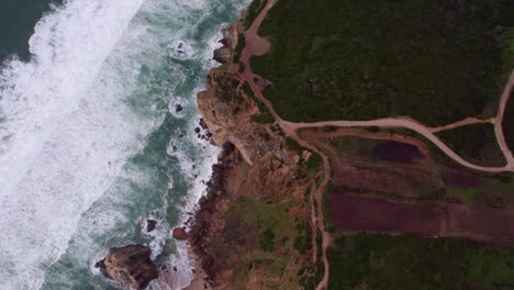 top down view of high cliffs coast near cabo da roca during sunset, aerial