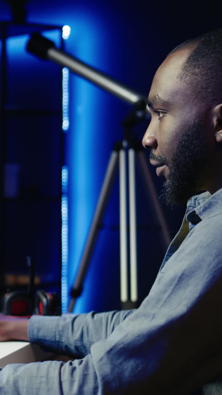 Vertical video Man in neon lit apartment playing immersive video games