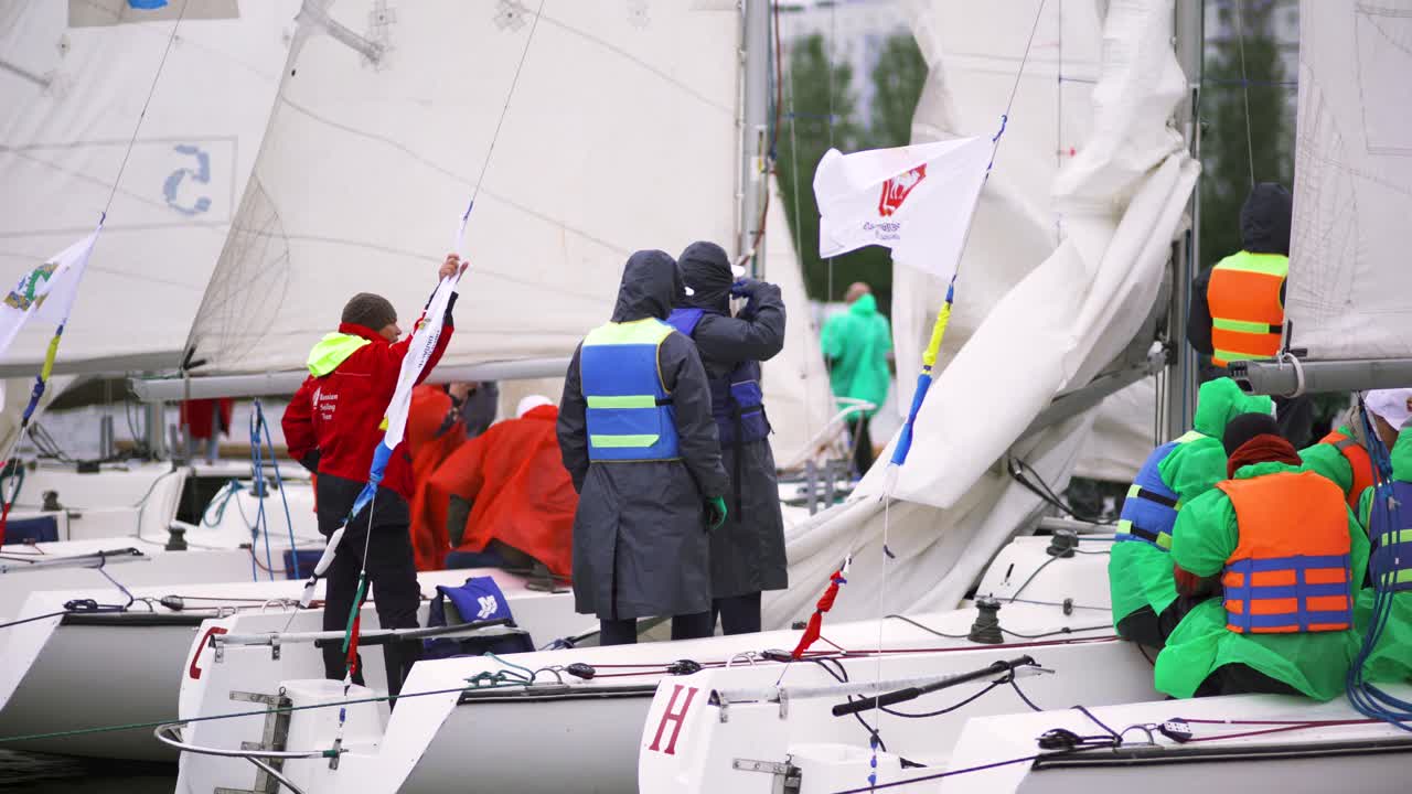 Sailboats and Sailors Preparing for a Regatta