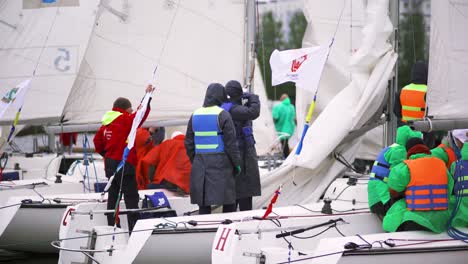 sailboats and sailors preparing for a regatta