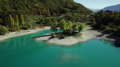 Mountain-blue-water-lake-in-Italian-Alps-Dolomites-with-trees-and-peaks-drone-aerial