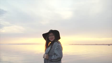 woman enjoying a sunset by the river