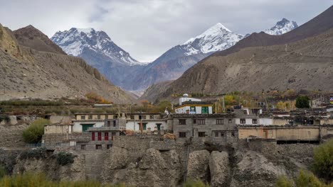 a time-lapse video of clouds moving over the rugged himalaya mountains with the town of kagbeni in the mustang region of nepal