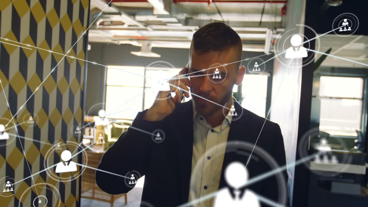 Animation of network of connections with icons over caucasian businessman using smartphone